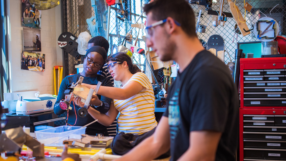 Students build a robot in the lab as part of MITES, one of MIT's summer STEM program