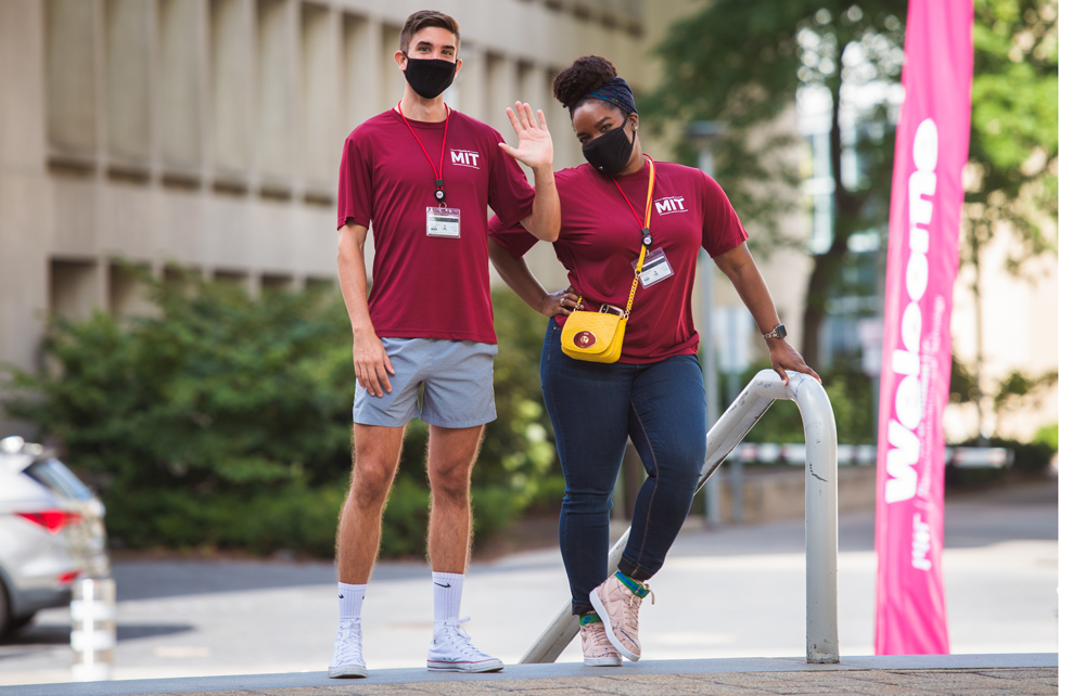 2 MIT greeters standing next to welcome sign on Move-in Day
