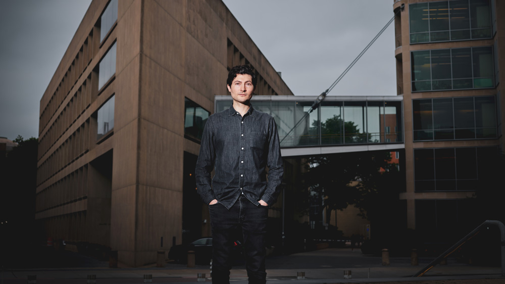 David Kasnter stands at Ames street with Building 66 in background