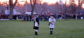 Two minutemen passing time; vans from channels 5 & 7 are in the background.