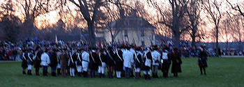 The minutemen formed up in two lines to await the arrival of the British.  I believe the figure by himself on the right is Captain Parker.