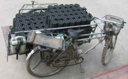 rickshaw load of cylindrical briquettes