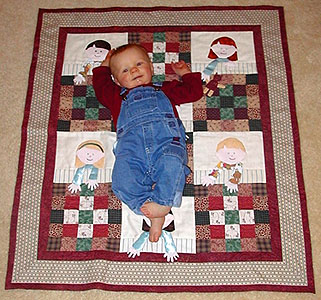 Trent, lounging and smiling on the 
quilt