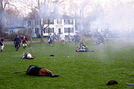 Minutemen fleeing the green amidst a lot of smoke.  The white building is the Harrington house.