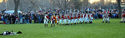 The Btitish march from the field.  A fallen colonial lies on the field.