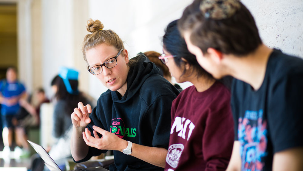 Three students sitting and talking at MIT