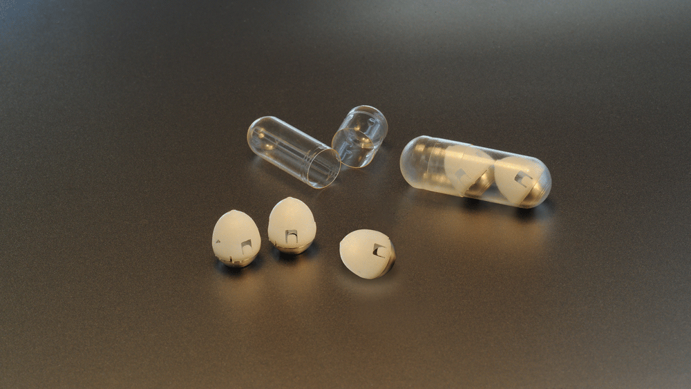capsules for oral insulin delivery lying on a shiny gold surface