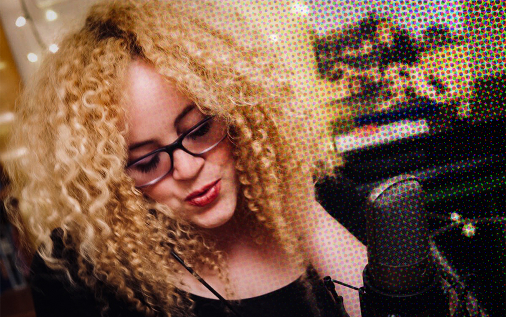 Samantha Farrell singing into a microphone