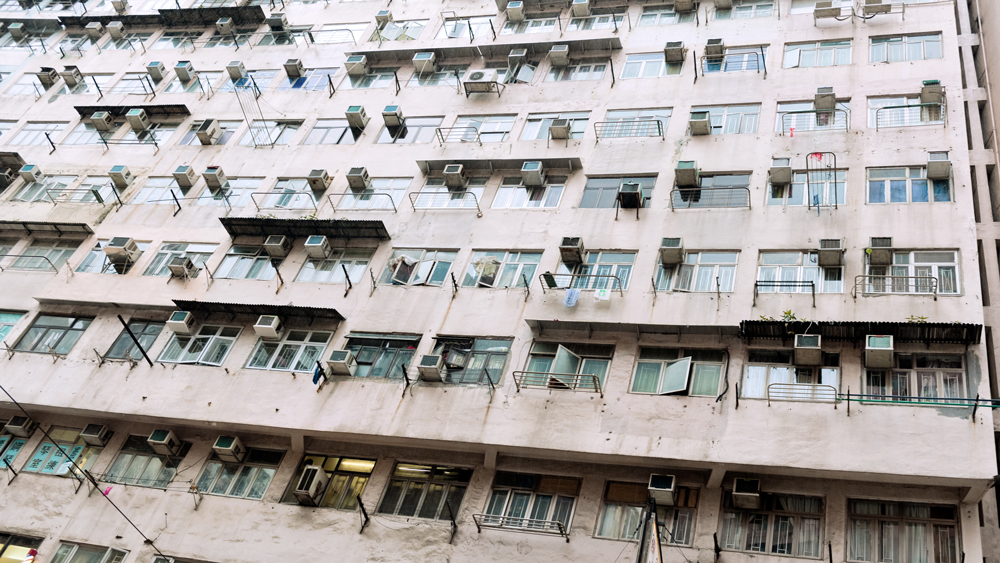 Apartment building with many air conditioners outside