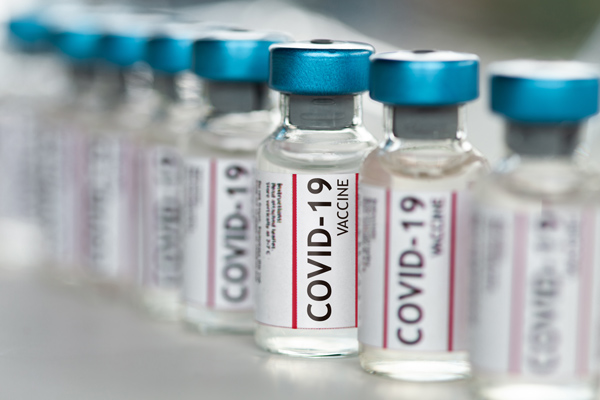 a row of vials containing the Covid-19 vaccine