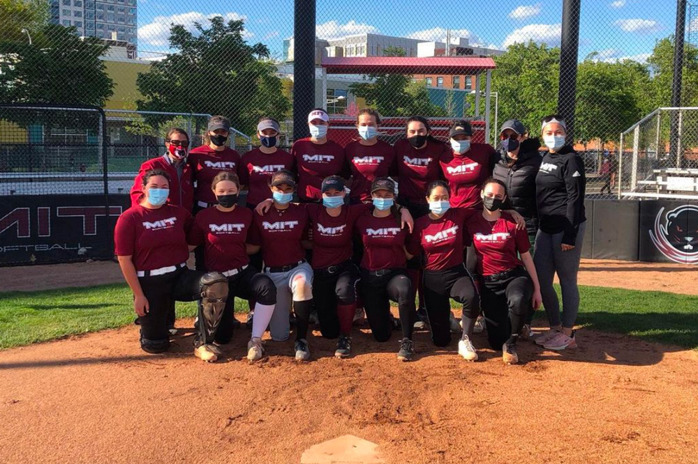 softball team together outside with masks