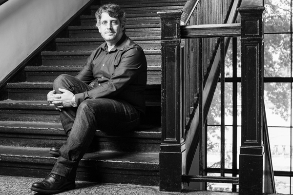 Themistoklis Sapsis sitting in a stairwell at MIT