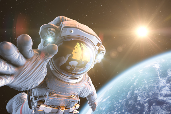 An astronaut in space above Earth