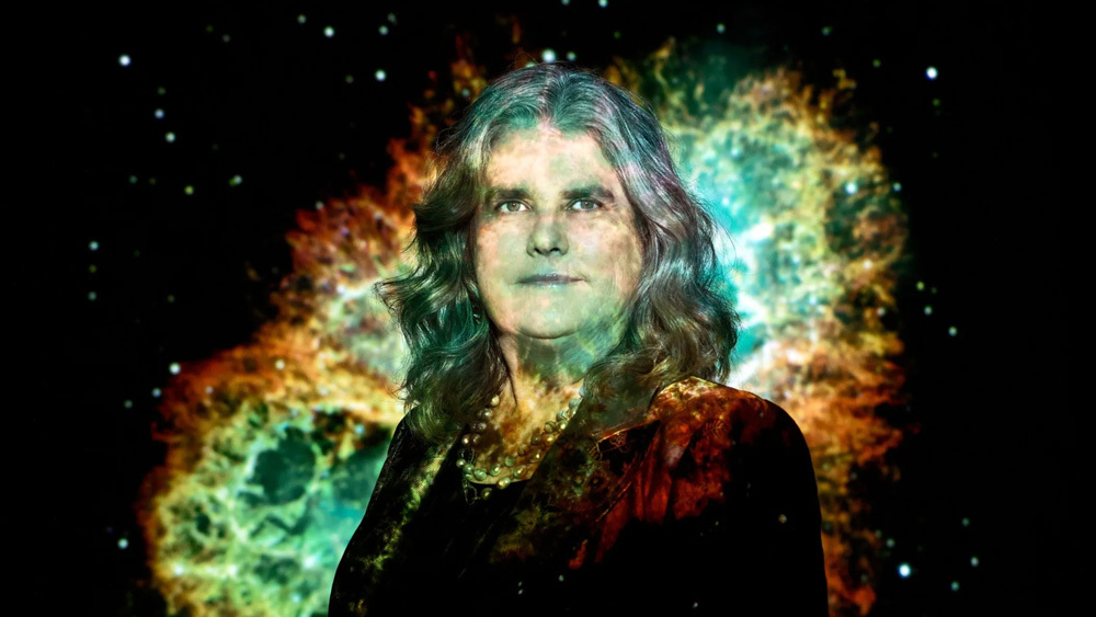 Artistic photo portrait of Andrea Ghez with image of a galaxy projected onto Ghez and background