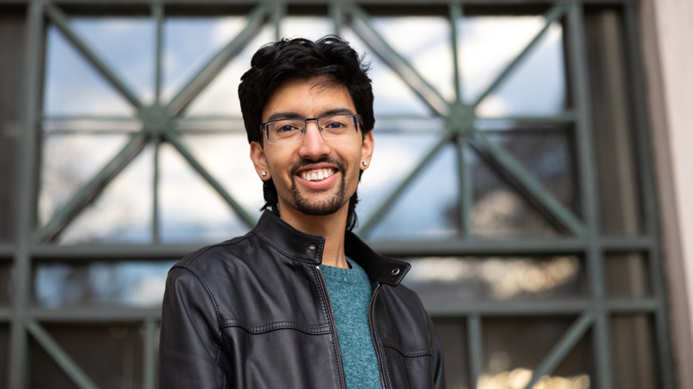 Portrait photo of Shardul Chiplunkar with windows in background