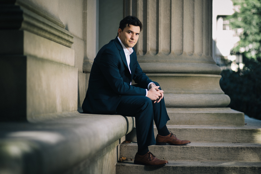 Photo of Max Williamson sitting near MIT's iconic columns 