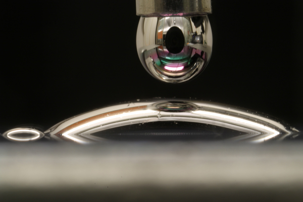 a drop of mercury spreading on a surface