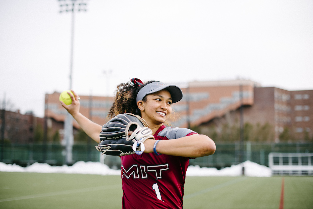 Player on the MIT Women Engineers softball team winds up to throw a ball.