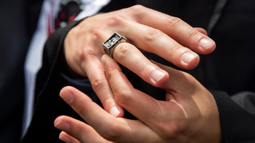 MIT's brass rat class ring on a graduate's hand
