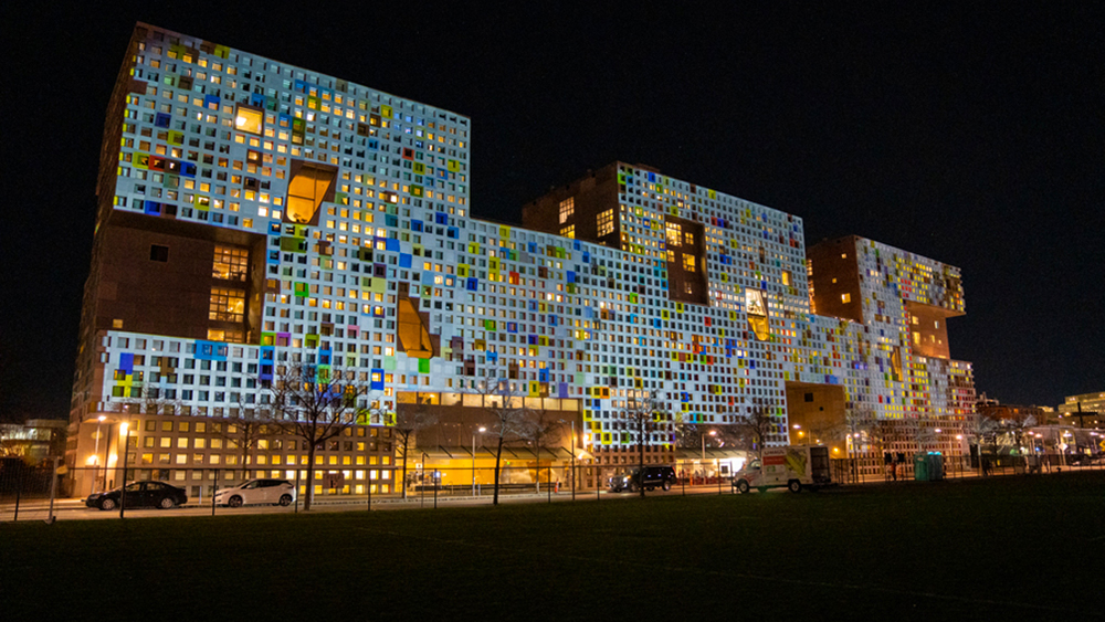 Simmons Hall covered in projected colorful lights 