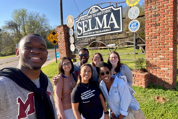 Students pose next to the “Welcome to Historic Selma” sign, in Alabama.