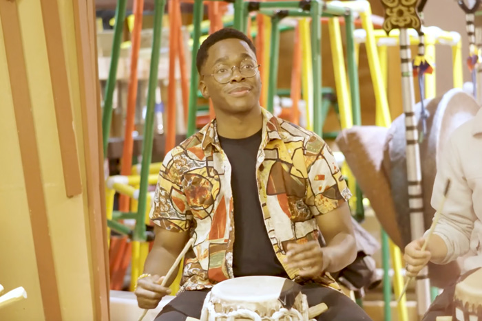 Ayomikun “Ayo” Ayodeji plays drums in a video still