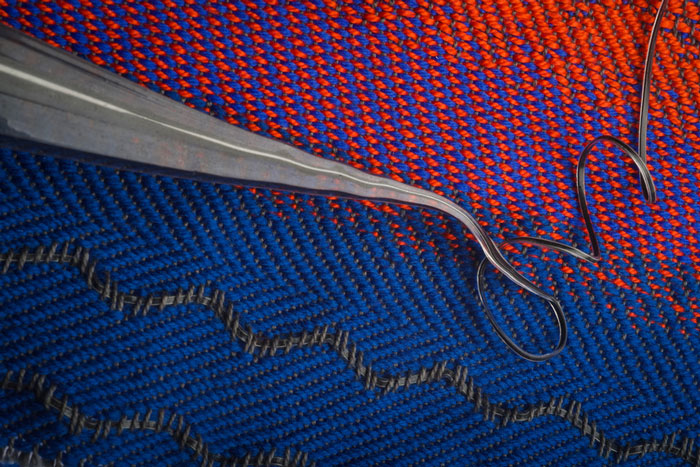 Photo shows a smart textile woven with red and blue fibers