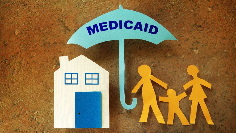 A paper-cutout collage shows a house and a family with an umbrella that says "Medicaid" 