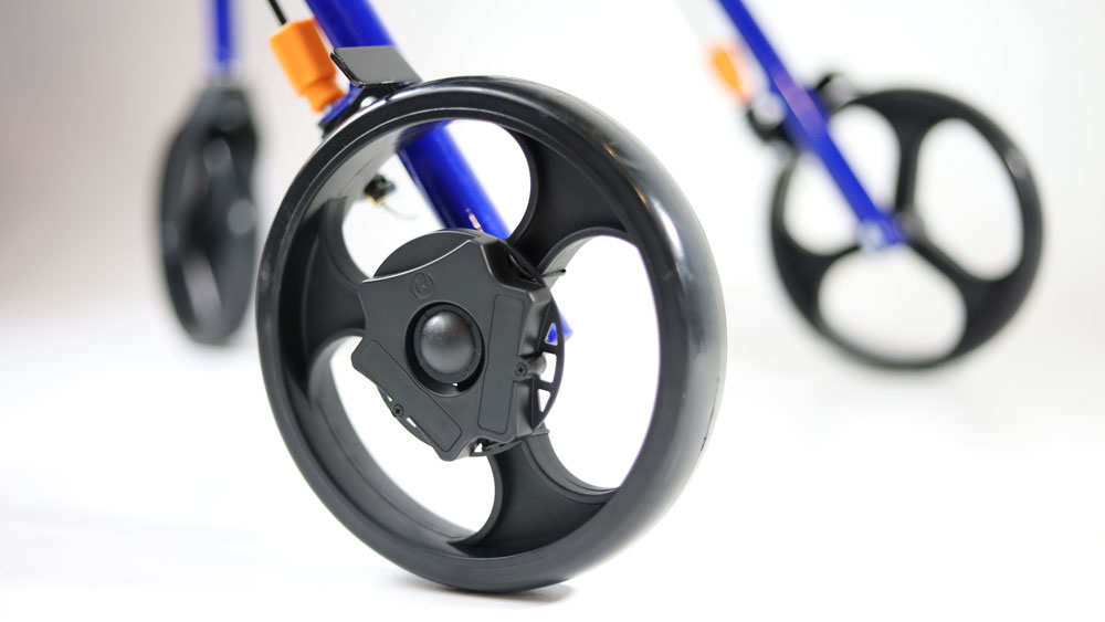Photo shows that the wheels of a walker have new WalkWise devices attached