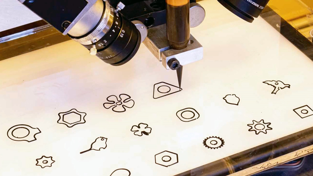 a 3D printer printing various shapes on a single surface