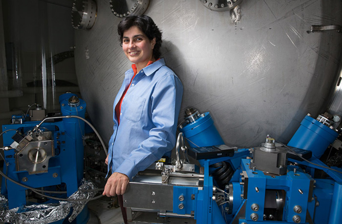 Nergis Mavalvala stands in front of the LIGO Advanced System Test Interferometer facility