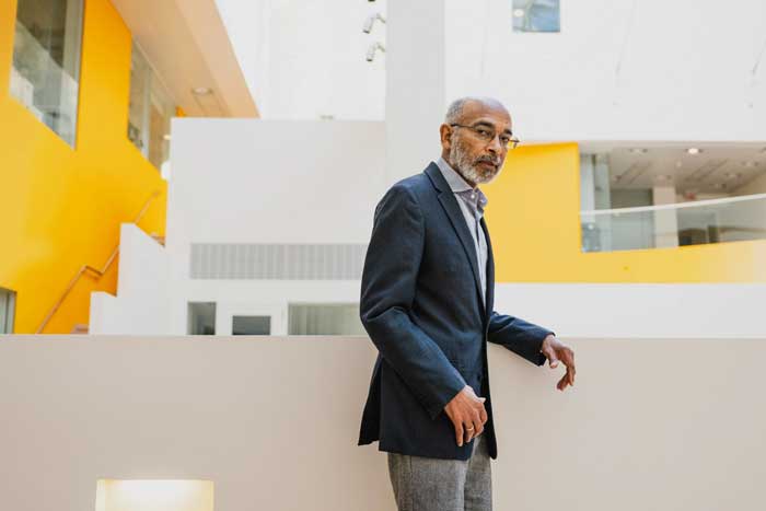 Emery Brown standing on an elevated walkway at MIT