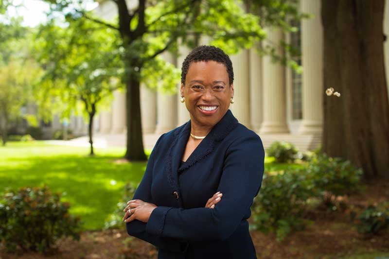 Melissa Nobles portrait outside in Killian Court with trees and grass in background