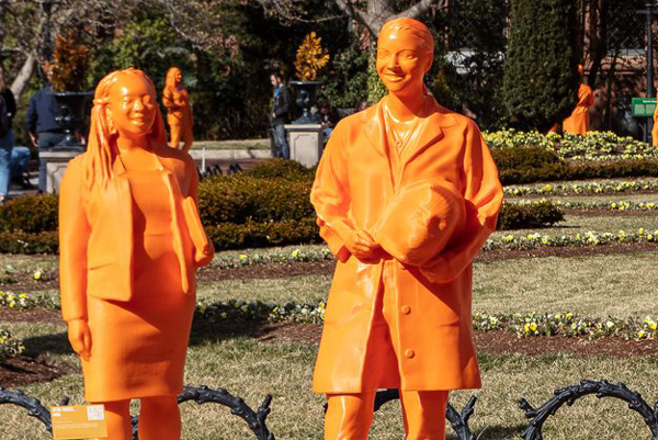 orange sculptures of women