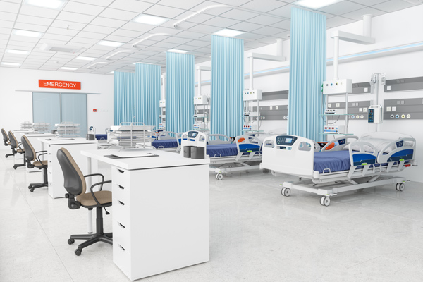 an empty emergency room with four sets of hospital beds and reception desks.