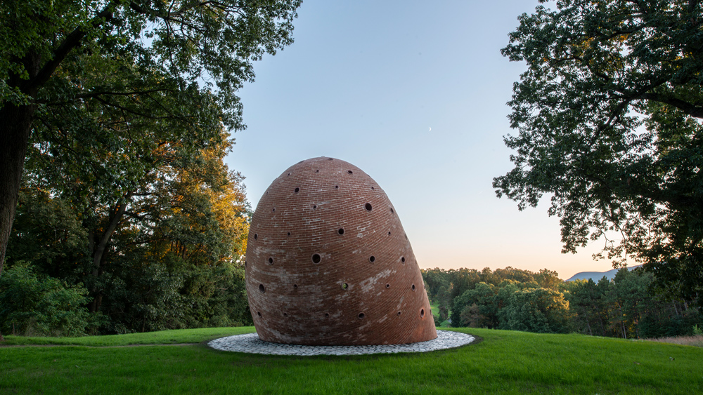 A view of the back of the brick sculpture, with a curved roof.