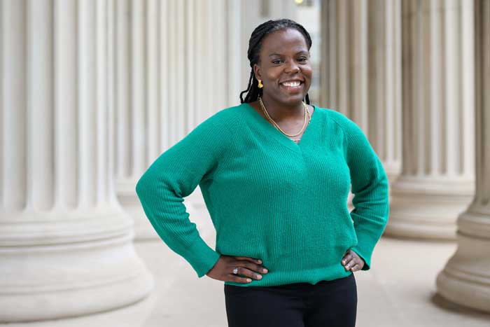 Asia Allison stands outside near MIT columns