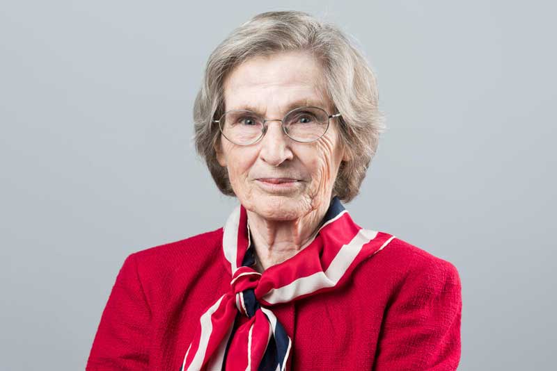 Portrait of Lotte Bailyn on gray background