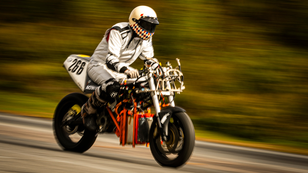 A person rides a hydrogen motorcycle with blurry background