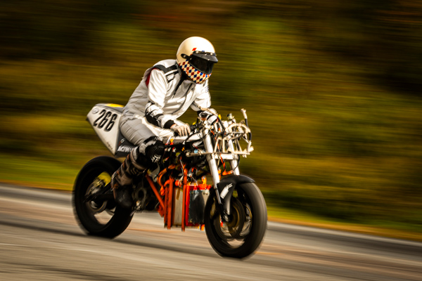 A person rides a hydrogen motorcycle with blurry background