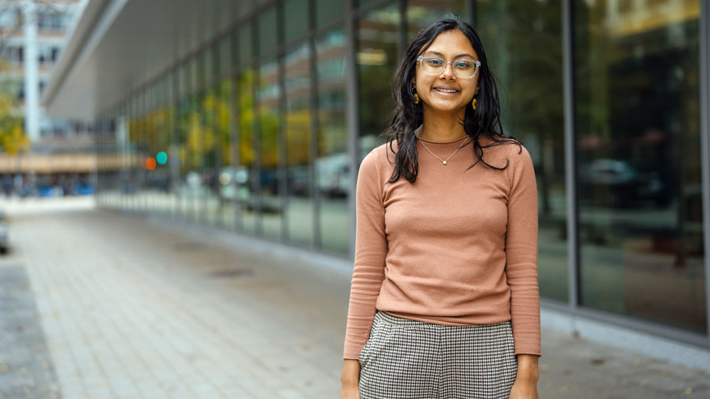 Anushree Chaudhuri stands outside