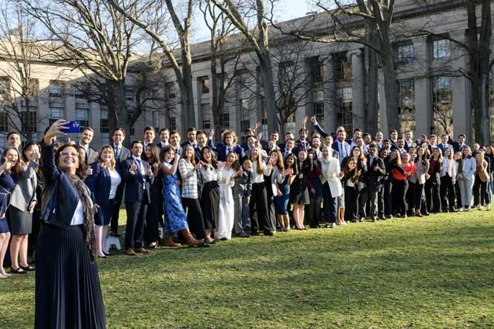 Group photo with dozens of people on Killian Court