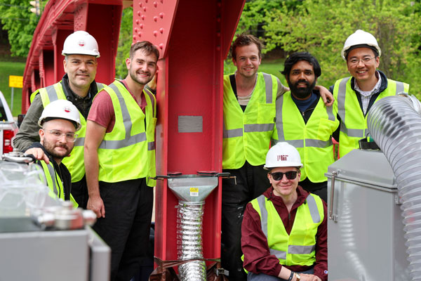 team next to bridge column