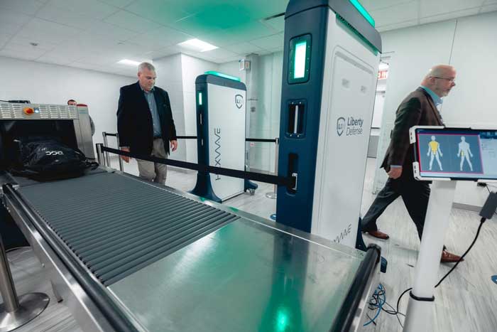 2 men walking through airport security screening