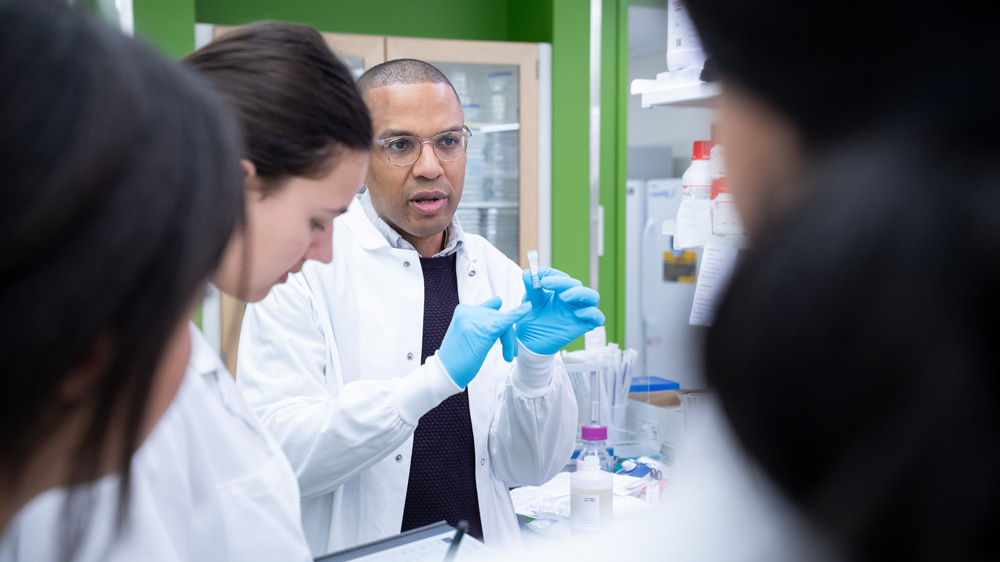Bryan Bryson in lab with students