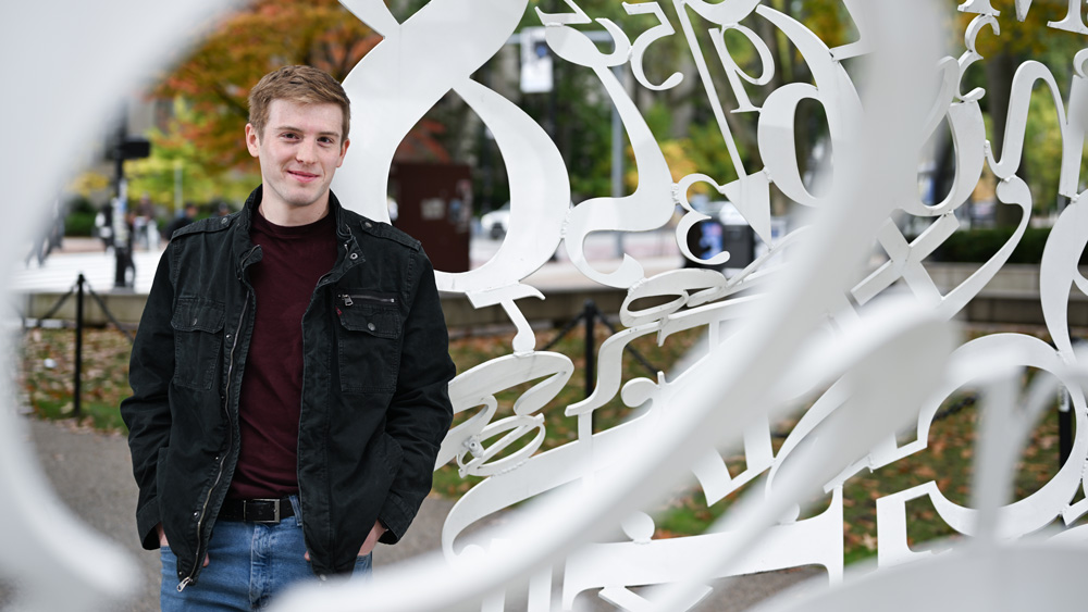 Taylor Hampson inside "The Alchemist" sculpture made of numbers