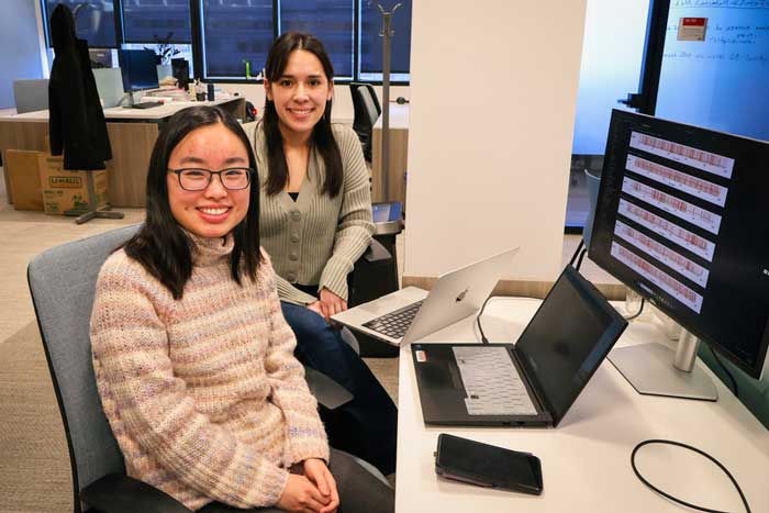 PhD students Tiffany Yau and Teya Bergamaschi with computers
