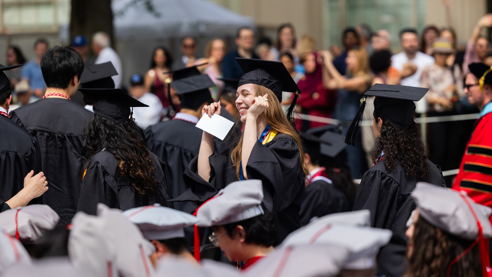 MIT grad pumping fist in the crowd