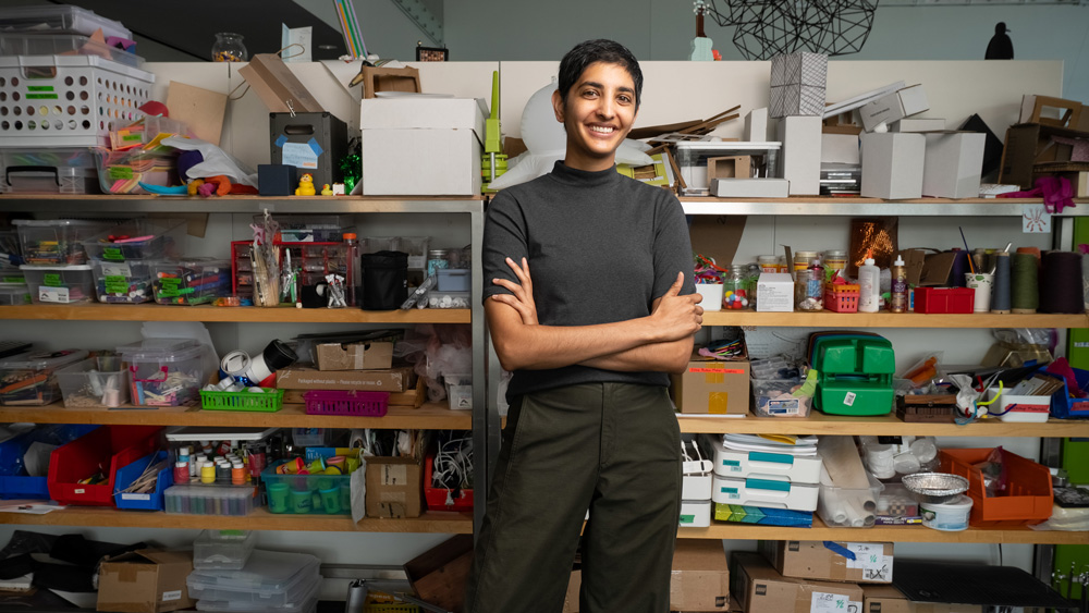 Ila Kumar in front of shelves full of art supplies