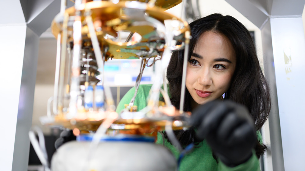 Close-up of Jessica Fry tending an experiment in the lab, with only her face in focus